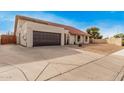 This home boasts a large driveway and a two-car garage, offering ample parking and storage at 5607 E Enrose St, Mesa, AZ 85205