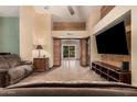 Spacious living room featuring wood accents, tile floors, and a modern entertainment center at 5607 E Enrose St, Mesa, AZ 85205