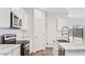 Bright kitchen with white cabinets, modern appliances and marble countertops at 5772 E Axle Ln, San Tan Valley, AZ 85140