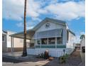 Charming home with covered parking and a decorative sunburst above the window at 60 S Jacknife Dr, Apache Junction, AZ 85119