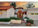 Lovely front entrance featuring a stone pillar entry, desert landscaping, and exterior lighting at 8717 E Spanish Barb Trl, Scottsdale, AZ 85258