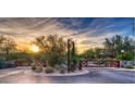 Community entrance showcasing a beautifully landscaped entry gate with sunset view at 8965 E Mountain Spring Rd, Scottsdale, AZ 85255