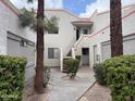 Inviting two-story condo exterior with landscaped courtyard, enhancing curb appeal at 985 N Granite Reef Rd # 134, Scottsdale, AZ 85257