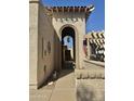Inviting courtyard entrance with arched entryway offering a warm welcome to the property at 10224 E Minnesota Ave, Sun Lakes, AZ 85248