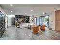 Large, open-concept living room with tile floors, modern furnishings, and patio access at 12209 N 66Th St, Scottsdale, AZ 85254