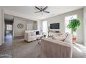 Comfortable living room with plush sofas, neutral decor, and a mounted television at 16137 W Quail Creek Ln, Surprise, AZ 85374