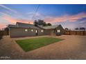 Large backyard area featuring a brick-lined artificial turf area and a wooden fence at 1642 E Turney Ave, Phoenix, AZ 85016