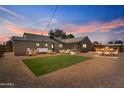 Spacious backyard with patio furniture, artificial grass, and secure fencing perfect for outdoor enjoyment at 1642 E Turney Ave, Phoenix, AZ 85016