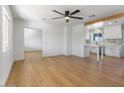 Spacious living room with wood floors, a ceiling fan, and an open kitchen at 1642 E Turney Ave, Phoenix, AZ 85016