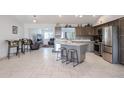 Modern kitchen featuring stainless steel appliances, kitchen island and an adjacent living space at 1699 Leisure World --, Mesa, AZ 85206