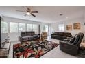 Bright living room featuring neutral-toned sofas, a patterned rug, and large windows at 1699 Leisure World --, Mesa, AZ 85206