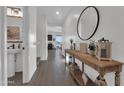 Bright entryway featuring a decorative console table, mirror, and tile flooring throughout at 23290 N 175Th Ln, Surprise, AZ 85387