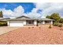 Charming single-story home featuring a two car garage and low maintenance desert landscaping in the front yard at 2540 E Riviera Dr, Tempe, AZ 85282