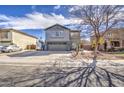 Beautiful two-story home with gray stucco, a well-manicured lawn, and a spacious driveway in a sunny neighborhood at 2607 W Ironstone Ave, Apache Junction, AZ 85120