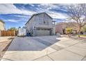 Attractive two-story home with gray stucco, an attached garage, and a wide driveway for easy parking at 2607 W Ironstone Ave, Apache Junction, AZ 85120