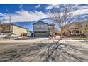 Inviting two-story home with well-kept landscaping, set in a peaceful neighborhood on a street with mature trees at 2607 W Ironstone Ave, Apache Junction, AZ 85120
