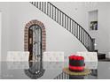 Beautifully decorated dining room with an archway, dark floors, and stairs at 280 W Wisteria Pl, Chandler, AZ 85248
