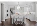 Bright kitchen featuring a large island with seating and modern lighting fixtures at 280 W Wisteria Pl, Chandler, AZ 85248
