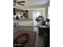 Open living room and kitchen featuring dark cabinetry and modern appliances at 30386 N Juniper Dr, Florence, AZ 85132