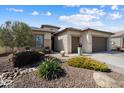 Charming single-story home with a well-maintained front yard and three-car garage at 3074 N 167Th Dr, Goodyear, AZ 85395