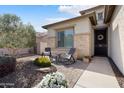 Inviting front porch with cozy seating, decorative pillows, and a welcoming atmosphere at 3074 N 167Th Dr, Goodyear, AZ 85395