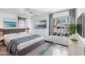 Cozy bedroom with a queen-sized bed, ceiling fan, and a picture window with natural light at 3500 N Hayden Rd # 2201, Scottsdale, AZ 85251