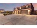 Charming two-story home with a stone-accented facade and a spacious three-car garage at 3840 W Brogan Ct, New River, AZ 85087