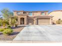 Charming two-story home with a stone-accented facade and a spacious three-car garage at 3840 W Brogan Ct, New River, AZ 85087
