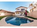 Beautiful backyard pool with an elevated patio and two-story home with a balcony at 4346 E Corral St, Phoenix, AZ 85044