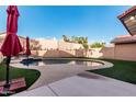 Relaxing backyard pool area with patio, umbrellas, and desert landscaping at 4346 E Corral St, Phoenix, AZ 85044