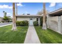 Charming home exterior with mature landscaping, a walkway, and a serene curb appeal at 4800 N 68Th St # 225, Scottsdale, AZ 85251