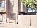A view of the residence showing the architectural design, with beige siding, and a small yard at 5316 W Lynwood St, Phoenix, AZ 85043