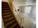 View of the living room from the stairs featuring light gray wood-look flooring at 5420 W Lynwood St, Phoenix, AZ 85043