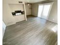 Living room featuring light gray wood-look flooring, ceiling fan, and natural light at 5420 W Lynwood St, Phoenix, AZ 85043