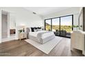 Bright main bedroom featuring golf course views, a sitting area, and access to a private balcony at 6331 E Phoenician Blvd # 6, Scottsdale, AZ 85251