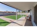 Covered patio with seating overlooks the expansive, well-maintained backyard at 7807 E Palm Ln, Scottsdale, AZ 85257