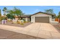 This charming one story home features desert landscaping, warm paint and a convenient two-car garage at 9621 N 83Rd Way, Scottsdale, AZ 85258