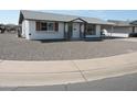 This house has white exterior paint and desert landscaping at 9923 W Hope N Cir, Sun City, AZ 85351