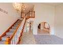 Bright foyer featuring an elegant staircase, high ceilings, and an open floor plan at 10421 N 77Th Pl, Scottsdale, AZ 85258