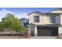 Two-story home featuring an attached garage and desert landscaping in a serene, scenic neighborhood at 1119 E Mcneil St, Phoenix, AZ 85042