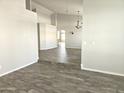 Open-concept living room featuring wood-look tile floors and neutral wall colors at 1119 E Southshore Dr, Gilbert, AZ 85234