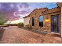 Charming exterior with stone accents and black-framed windows, complementing the tiled roof at 12980 E Cochise Rd, Scottsdale, AZ 85259