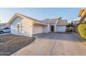 Single-story home with a tile roof, desert landscaping, a driveway, and an attached garage at 1360 W Folley St, Chandler, AZ 85224