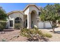 Charming stucco home featuring a well-maintained front yard, inviting curb appeal, and a two-car garage at 16008 S 13Th Way, Phoenix, AZ 85048
