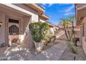 Charming front entrance with well-maintained desert landscaping, a tiled roof, and a sunny sky at 16014 W Kino Dr, Surprise, AZ 85374