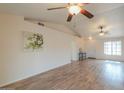 Spacious living room featuring wood-look flooring, high ceilings, and neutral walls at 1668 E Valerie St, Casa Grande, AZ 85122