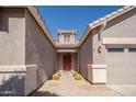 Inviting front entrance with well-manicured desert plants leading to the front door at 17768 W Maui Ln, Surprise, AZ 85388