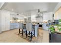 Spacious open kitchen featuring white cabinetry, a center island with breakfast bar and updated appliances at 17801 N 43Rd Way, Phoenix, AZ 85032