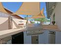 Well-equipped outdoor kitchen with grill and ample counter space at 17801 N 43Rd Way, Phoenix, AZ 85032