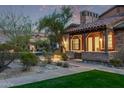 Beautiful stone home with a covered porch, meticulously landscaped front yard, and tiled roof in a tranquil neighborhood at 17902 N 93Rd Way, Scottsdale, AZ 85255